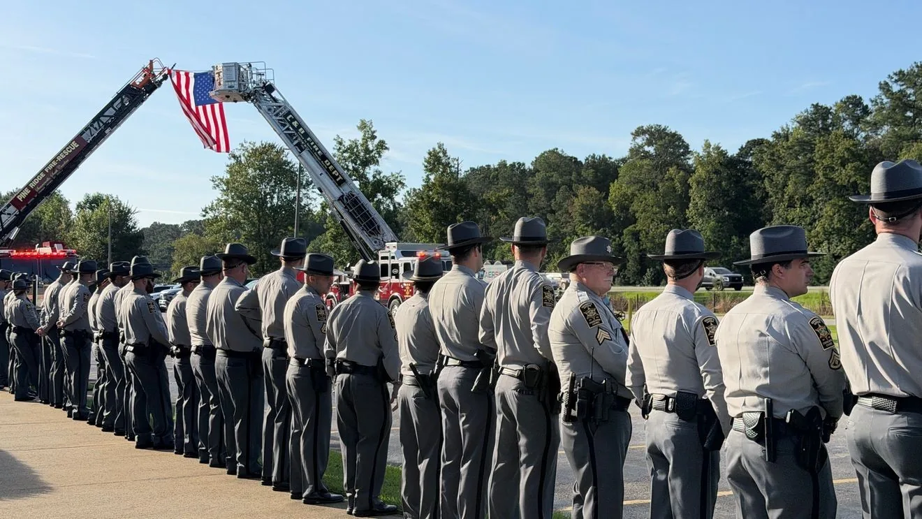 Law enforcement officers gather outside a church for a memorial service honoring Deputy Michael Hendricks