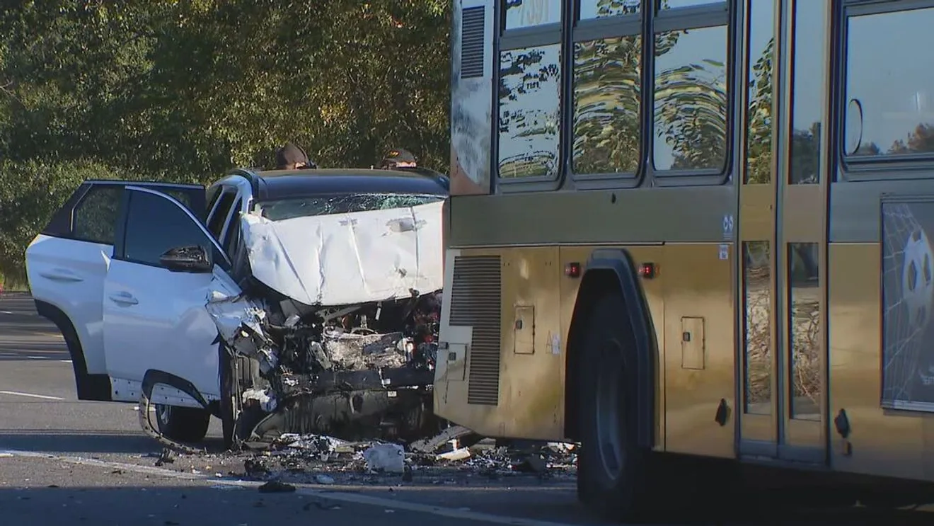 Police and investigators at a road crash scene involving a Metro bus and a damaged SUV